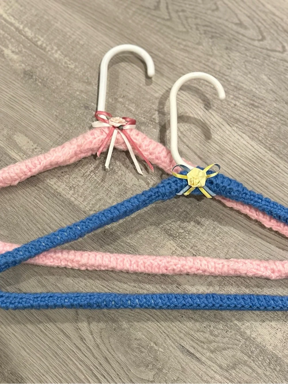 Handmade Pink and Blue Yarn-Covered Closet Hangers with Decorative Bows